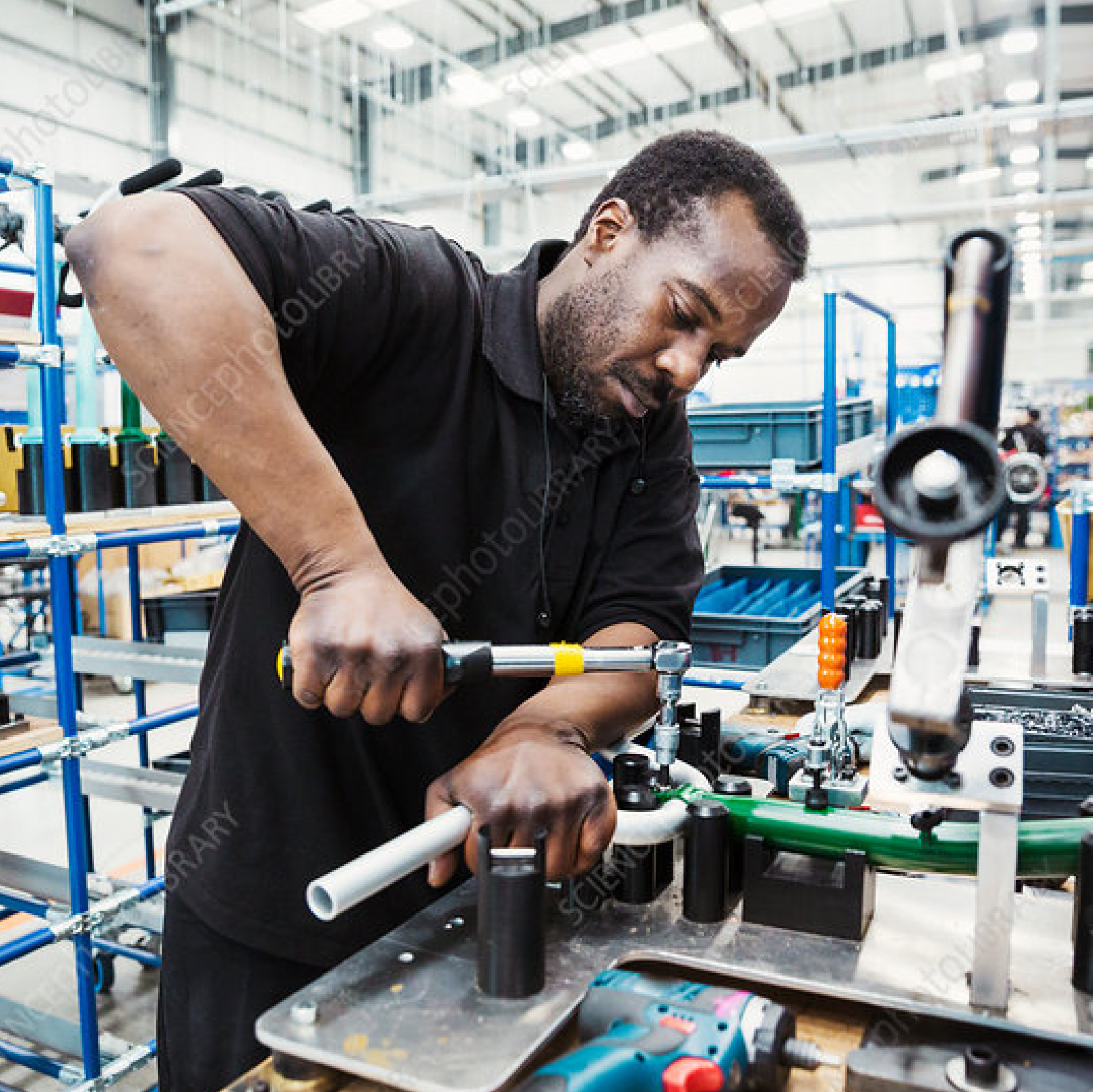 Worker assembling equipment in a factory