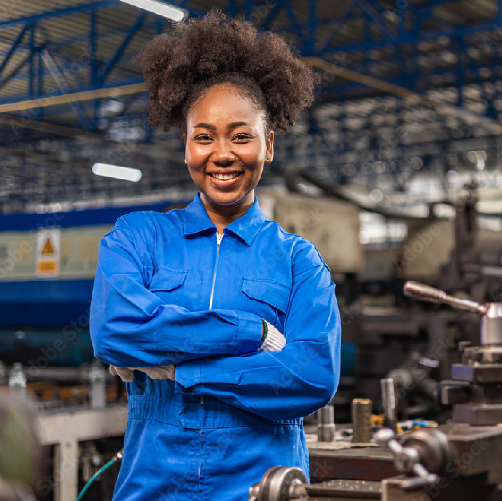 Smiling woman standing in a workshop